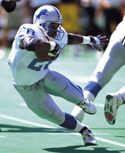Pro Football Hall of Famer Barry Sanders wearing number 21 for the Detroit Lions rushing the ball