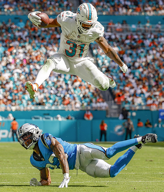 Second Place – Al Diaz, Miami Herald, “Mostert's Eye-Popping Hurdle,” Carolina Panthers at Miami Dolphins, Oct. 15, 2023.