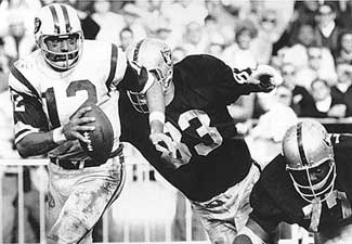 Namath scrambles from the pocket under a fierce rush by the Raiders in the famous 