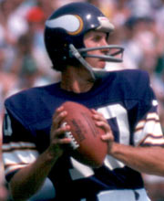 Pro Football Hall of Famer Fran Tarkenton wearing number 10 for the Minnesota Vikings dropping back for a pass