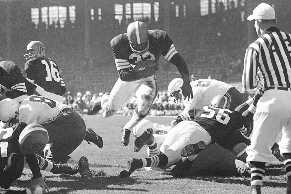 Cleveland Browns running back Jim Brown runs with the ball ni 1958.