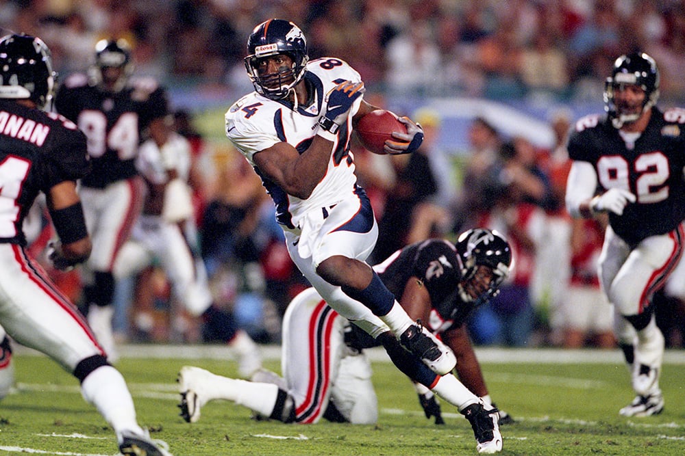 Hall of Fame tight end Shannon Sharpe carries the football.